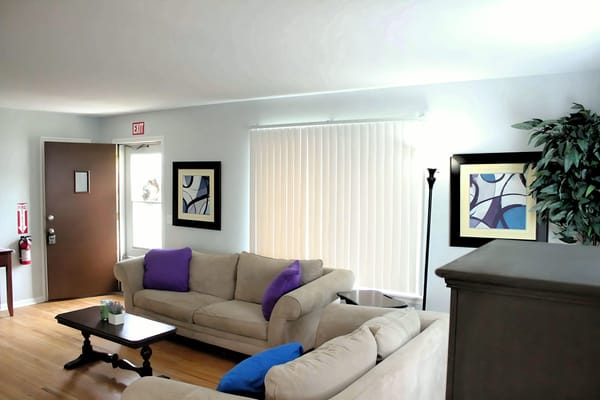 Comfortable living room with couches and artwork.