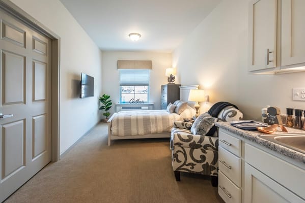 Cozy resident room with a bed and kitchenette