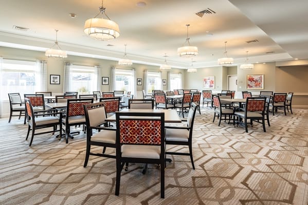 Bright and spacious dining room with tables and chairs
