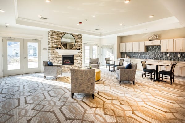 Bright common area with seating and a fireplace