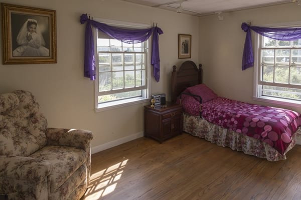 Cozy private room with floral chair and bed