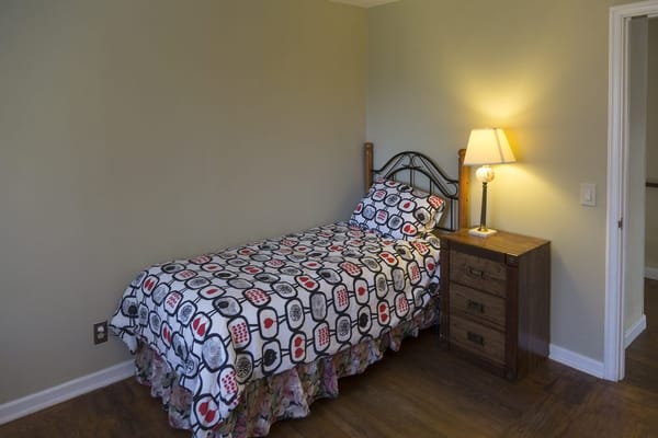 Cozy private room with a bed and lamp