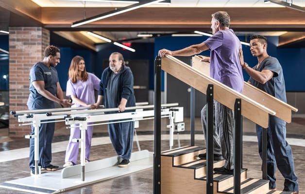 Residents participate in physical therapy with staff guidance.