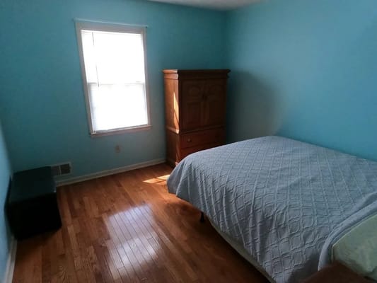 Bright and cozy bedroom with wooden furniture