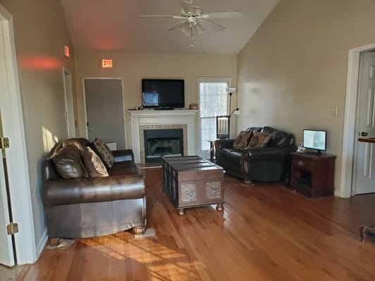 Inviting living room with leather sofas and wooden flooring.