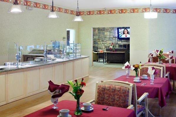 Spacious dining room with tables set for meals