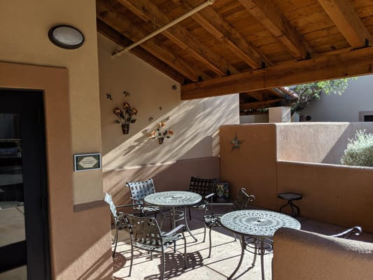 Outdoor seating area with tables and chairs