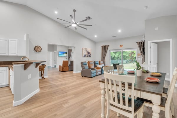 Bright interior common area with dining table and seating