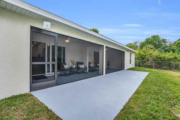 Exterior view of a care home with outdoor seating area