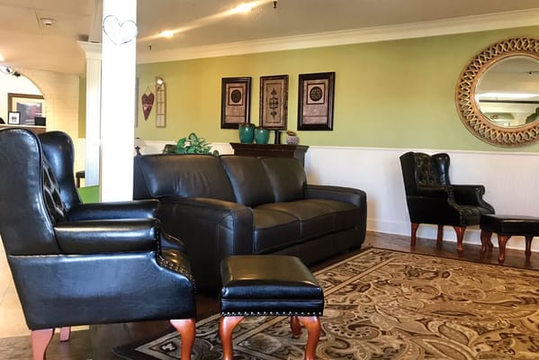 Cozy lounge area with dark leather seating and decorative elements