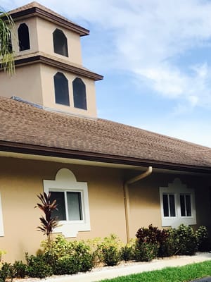 Exterior shot of The Colony Club Sunrise featuring a decorative roof and landscaped garden.