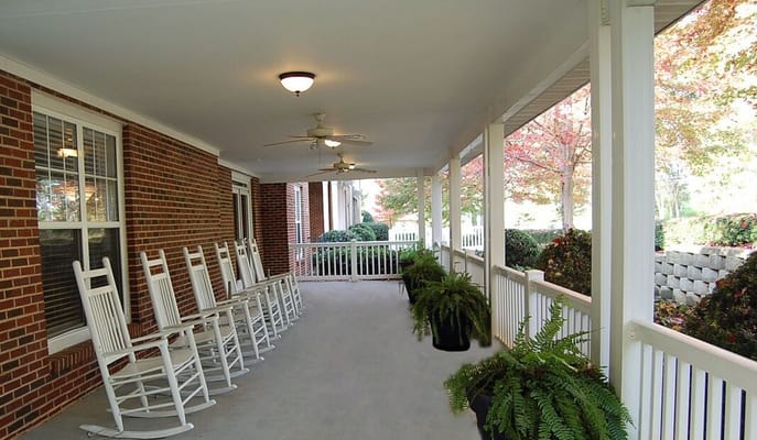 Porch with rocking chairs and potted ferns