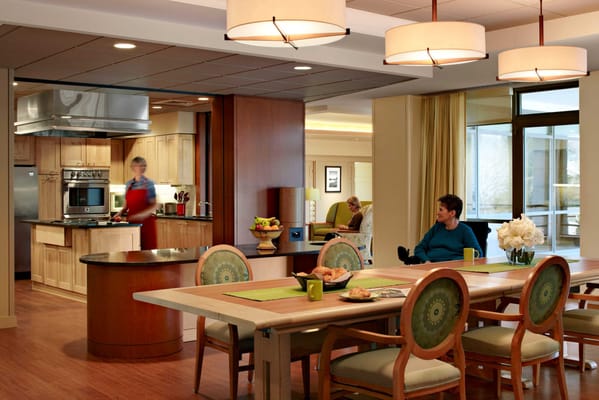 Common dining area with a kitchen and residents relaxing