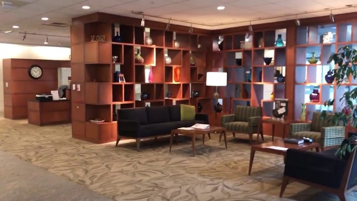 Spacious lobby with modern furniture and decorative wall shelves