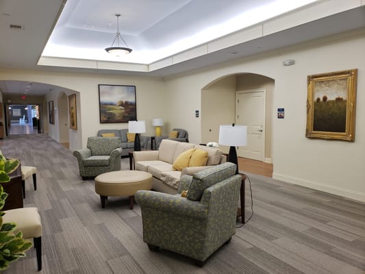 Cozy living room with seating, lamps, and artwork