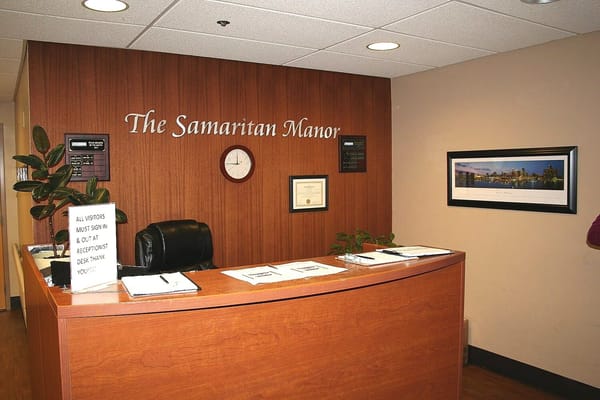 Reception area with desk and sign-in sheet