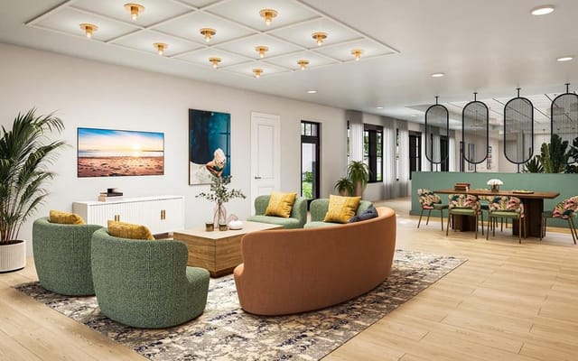 Bright and inviting living room with green and brown seating, a coffee table, and a dining area.