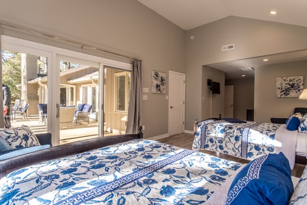 Stylish bedroom with floral bedding and access to outdoor space