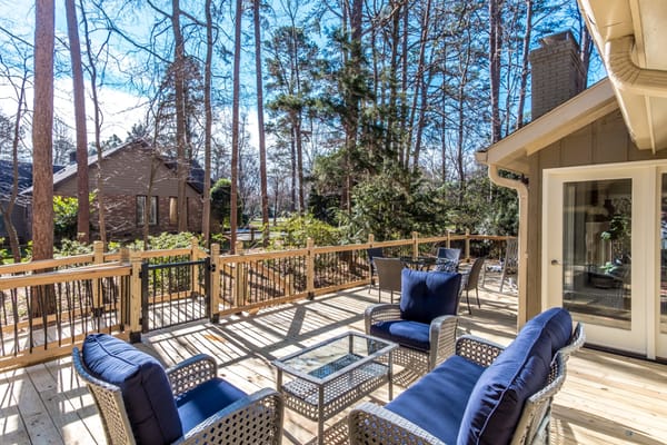Patio with seating surrounded by trees at The Sanctuary at Stonehaven.