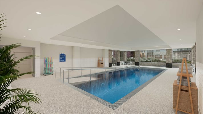 Indoor pool area with seating and plants