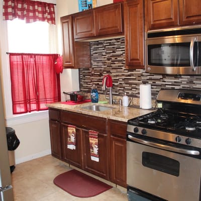 Well-equipped kitchen with granite countertops and red accents