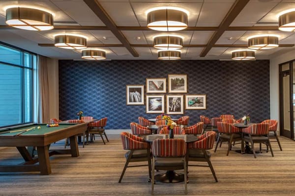 Bright common area with seating and pool table
