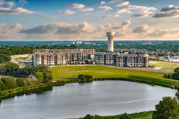 Aerial view of Touchmark at Emerald Lake with lake and greenery