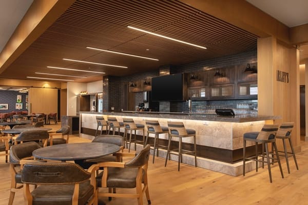 Modern dining area with bar seating and booths