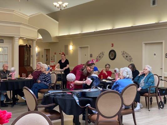 Residents enjoying a Valentine's Day event with decorations and refreshments.