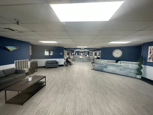 Spacious lobby area with seating and a reception desk