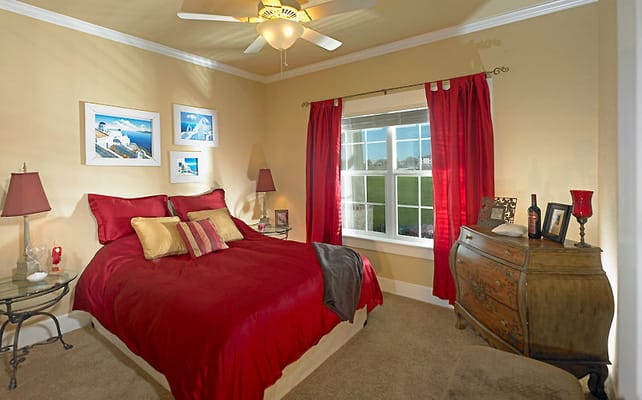 Bright bedroom with red accents and window view