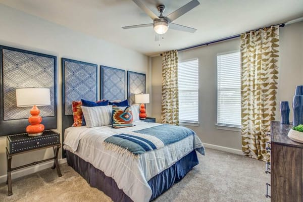 Cozy bedroom featuring a queen bed and decorative pillows