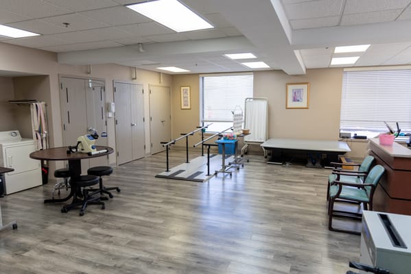 Interior of a therapy room with equipment in West Oaks Senior Care & Rehab Center