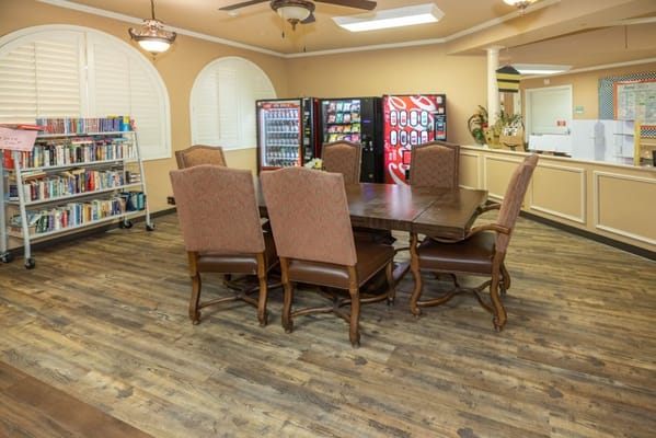 Interior view of a common area with seating and a bookshelf