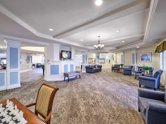 Bright and spacious common area with seating and a chess set