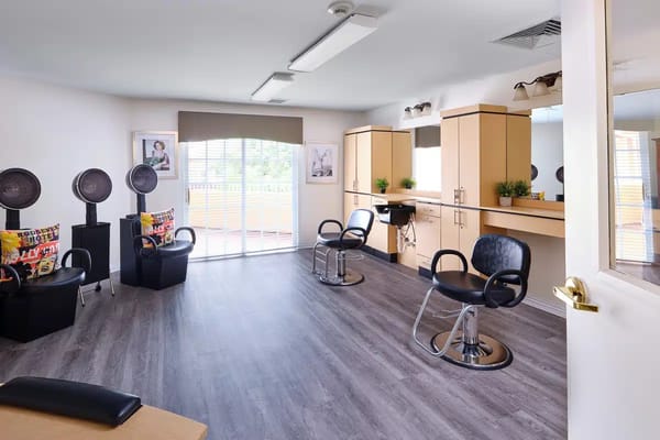 Bright hair salon area with styling chairs and natural light