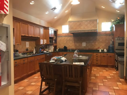 Kitchen interior with wooden cabinets and dining area