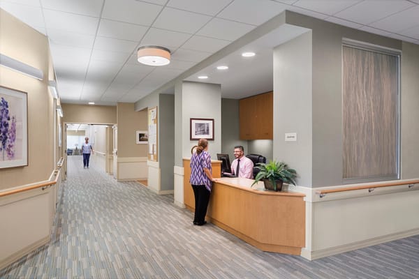 Reception area with staff assisting a resident