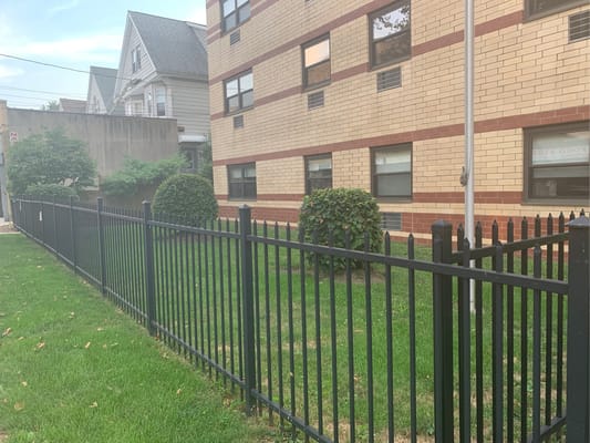 Fenced grass area next to a building at Woodstock Manor