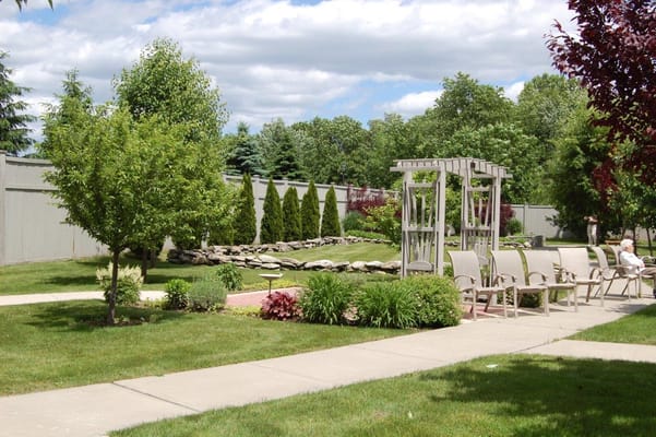 Outdoor garden with seating at Yorktown Assisted Living Residence
