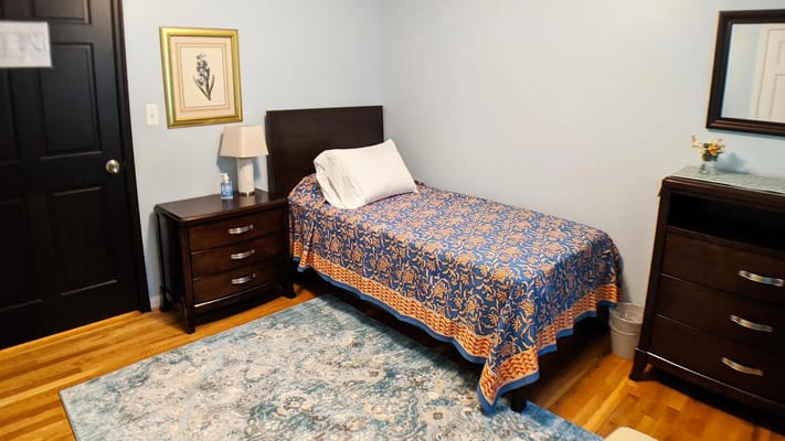 A private resident room with a bed and furniture