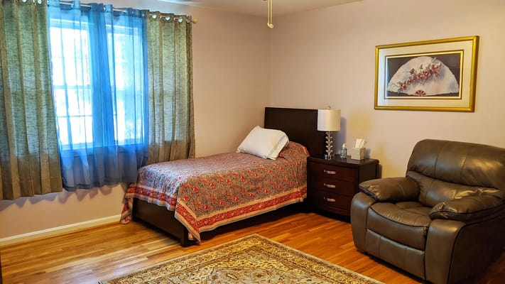 Cozy private room with a bed and recliner