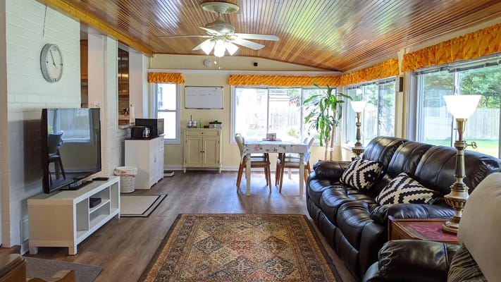 Bright common area with seating and dining table