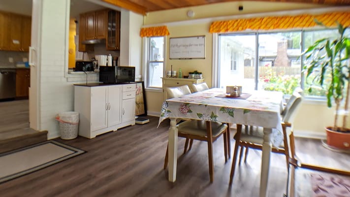 Bright common area with dining table and plants