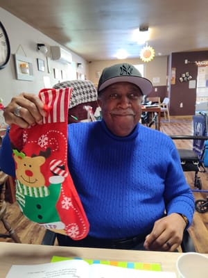 Resident holding a festive Christmas stocking