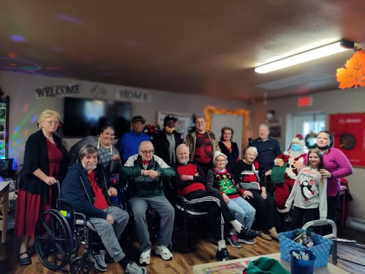 Group photo of residents and staff in a festive setting