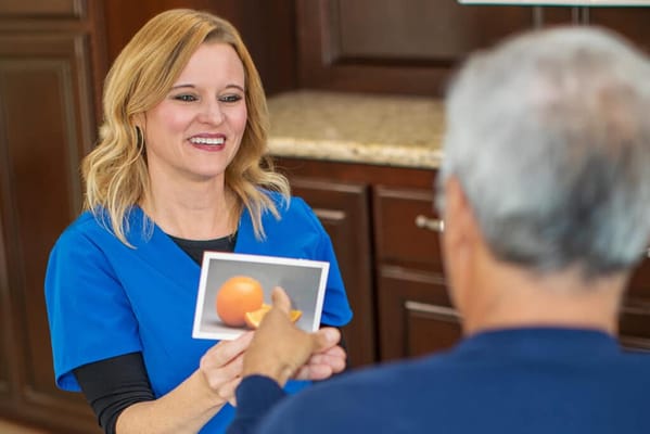 A nurse showing a photo to a resident