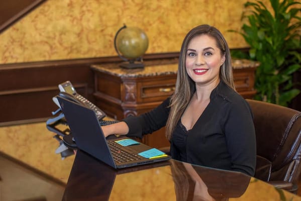 Receptionist at a desk in a warm interior setting