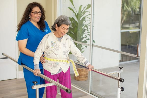 A caregiver assisting a resident during therapy.