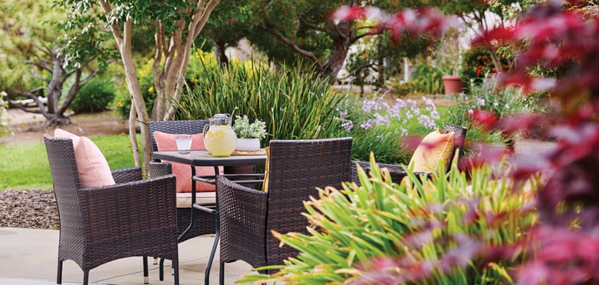 Outdoor seating area with a table and flowers